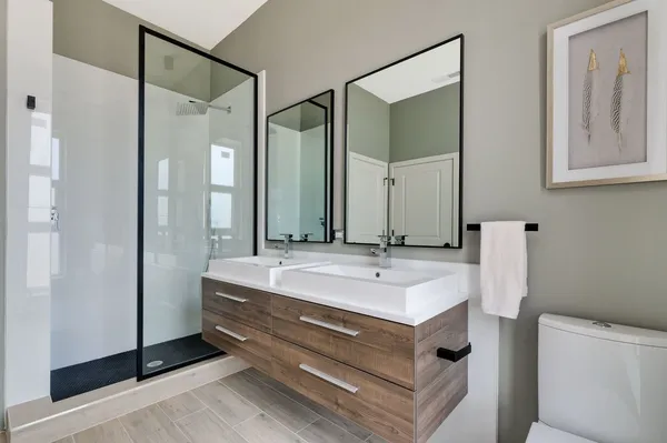 a bathroom with a double vanity sink mirror and double