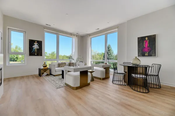 a living room with furniture and large windows