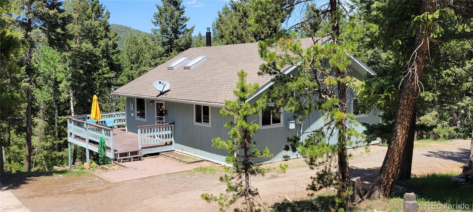 19533 Silver Ranch Road Conifer, CO 80433 - Photo 1 of 19 a view of house with yard and sitting area