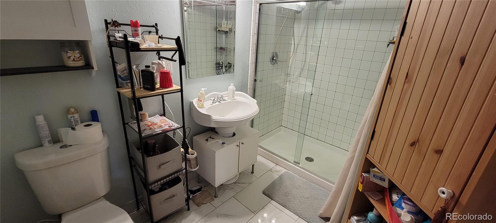 19533 Silver Ranch Road Conifer, CO 80433 - Photo 13 of 19 a bathroom with a toilet and a sink