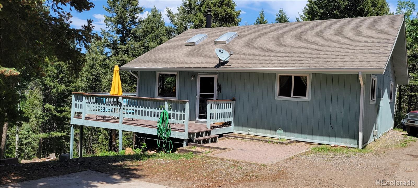19533 Silver Ranch Road Conifer, CO 80433 - Photo 19 of 19 a view of a house with roof deck