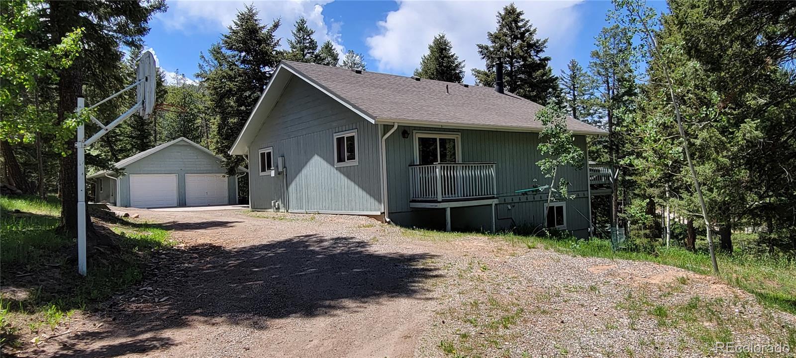 19533 Silver Ranch Road Conifer, CO 80433 - Photo 3 of 19 a view of a house with wooden fence