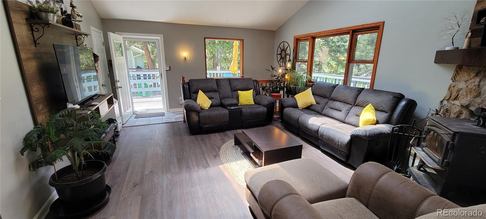 19533 Silver Ranch Road Conifer, CO 80433 - Photo 5 of 19 a living room with furniture and a flat screen tv