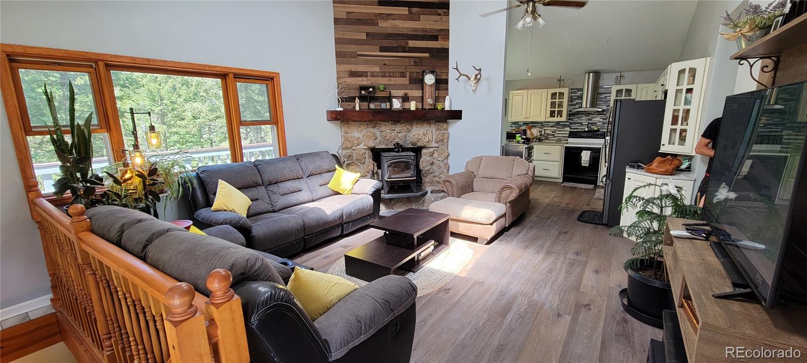 19533 Silver Ranch Road Conifer, CO 80433 - Photo 6 of 19 a living room with furniture fireplace and flat screen tv