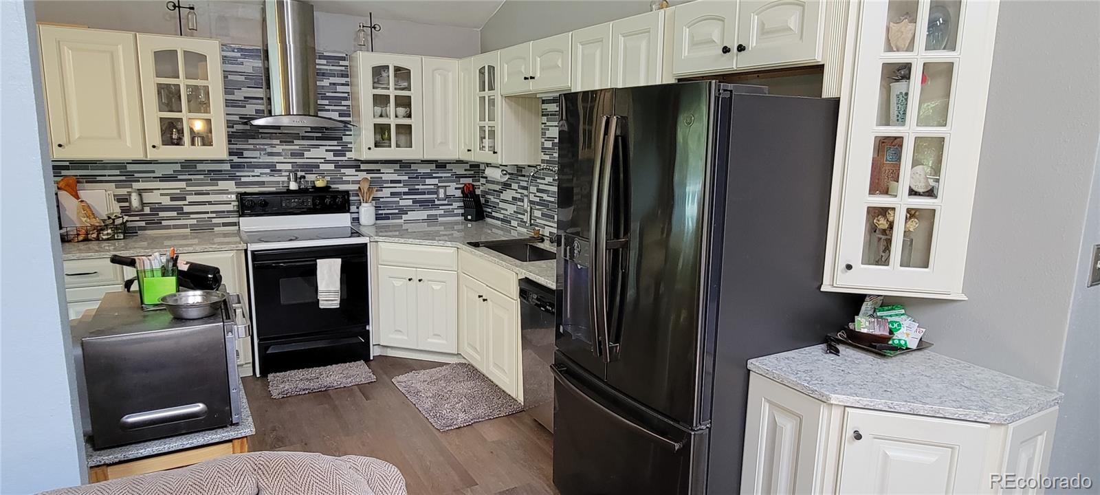 19533 Silver Ranch Road Conifer, CO 80433 - Photo 7 of 19 a kitchen with stainless steel appliances granite countertop a refrigerator and a stove