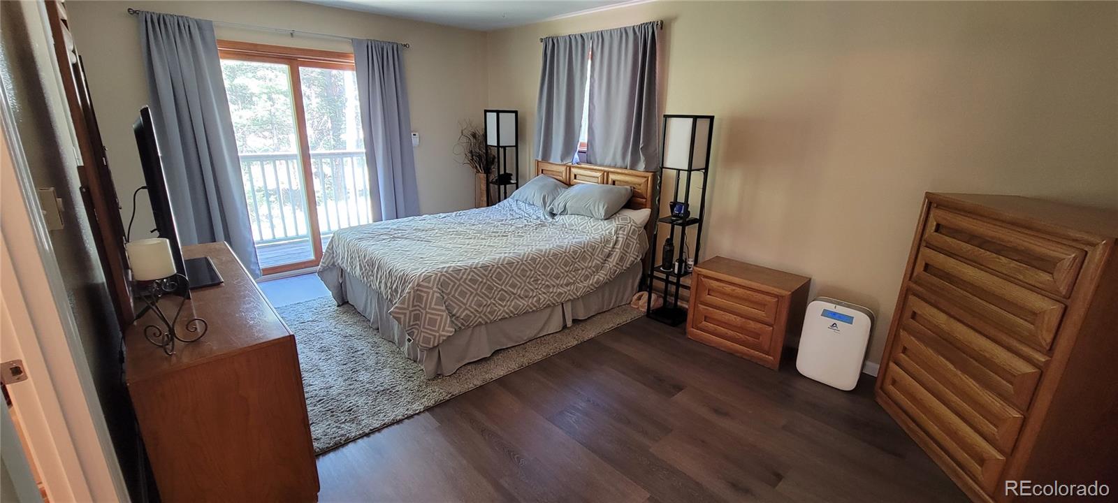 19533 Silver Ranch Road Conifer, CO 80433 - Photo 9 of 19 a bedroom with a bed and a mirror
