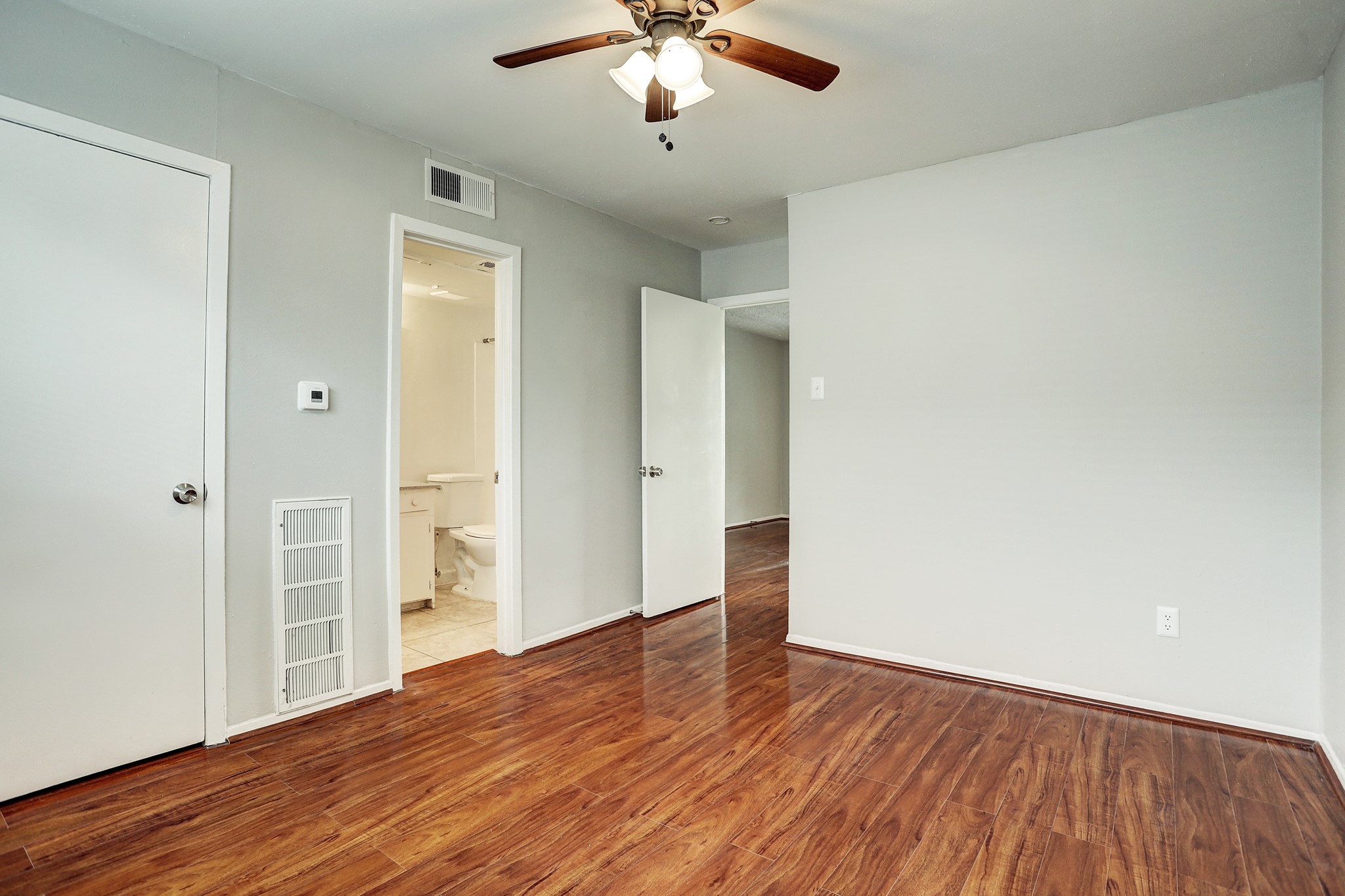 513 Ridge Street, Unit 21 Houston, TX 77009 - Photo 3 of 9 wooden floor in an empty room with a window