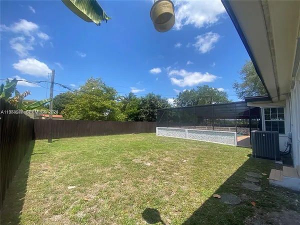 a kitchen with granite countertop a refrigerator and a sink
