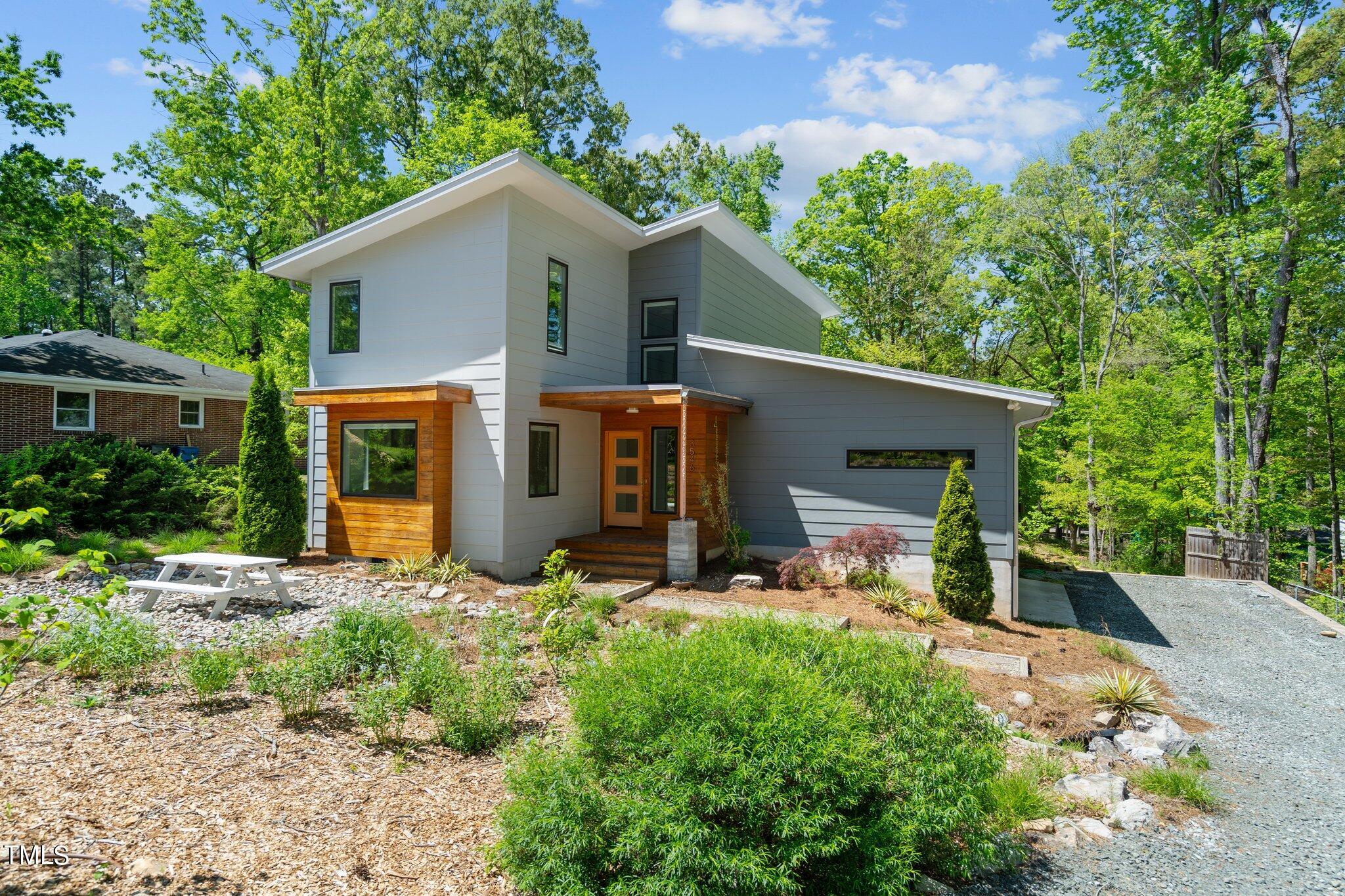 3546 Dixon Road Durham, NC 27707 - Photo 1 of 16 a front view of house with yard and trees in the background