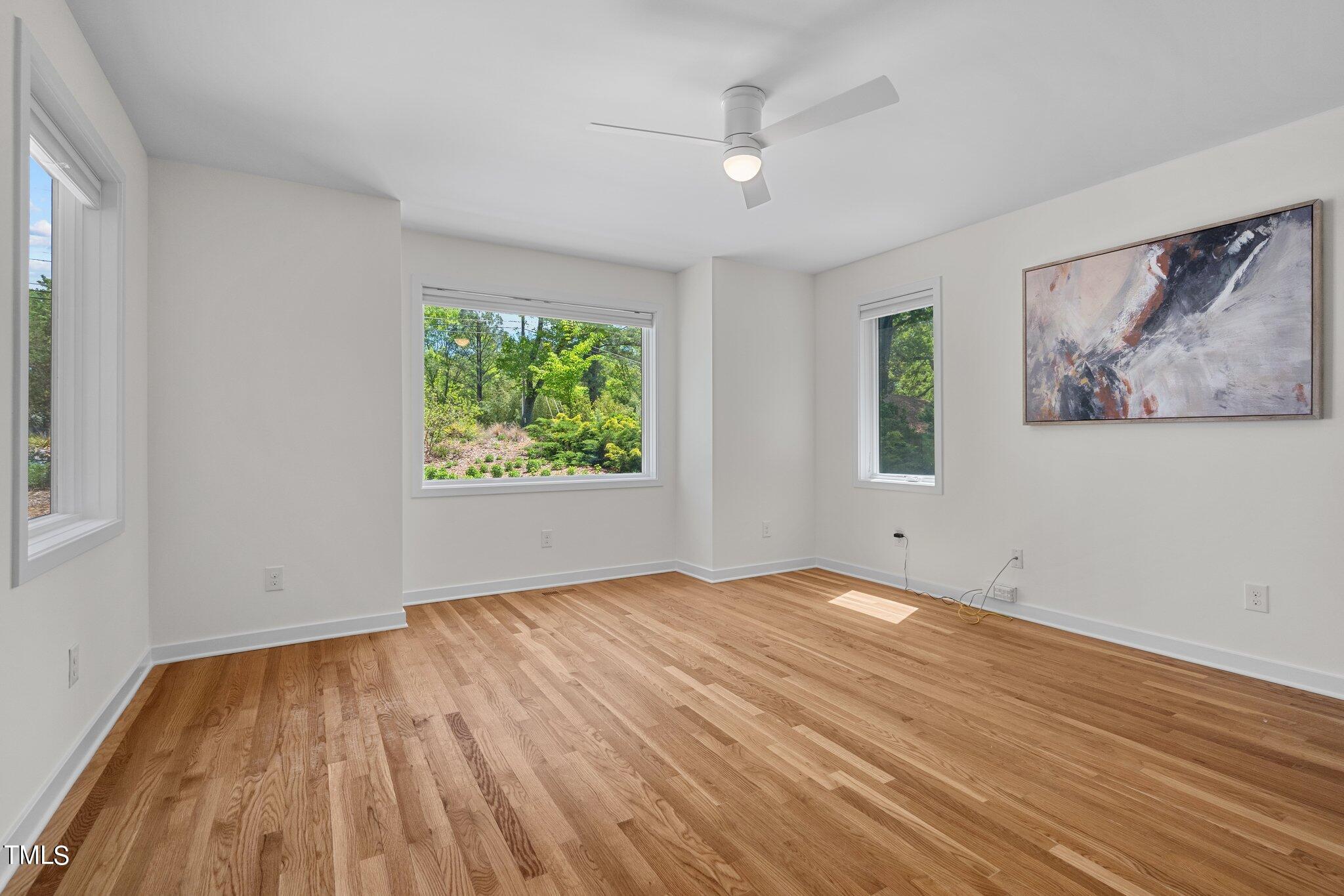 3546 Dixon Road Durham, NC 27707 - Photo 11 of 16 a view of empty room with wooden floor and fan