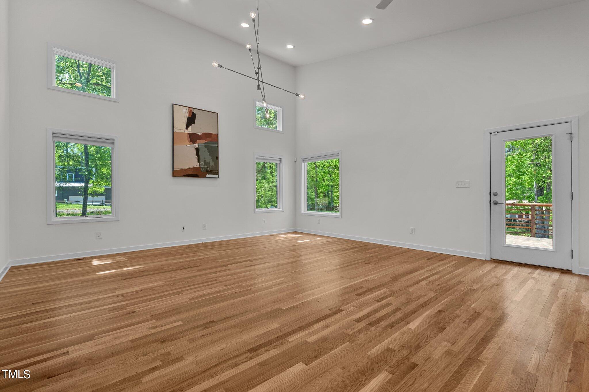 3546 Dixon Road Durham, NC 27707 - Photo 6 of 16 a view of an empty room with wooden floor and a window