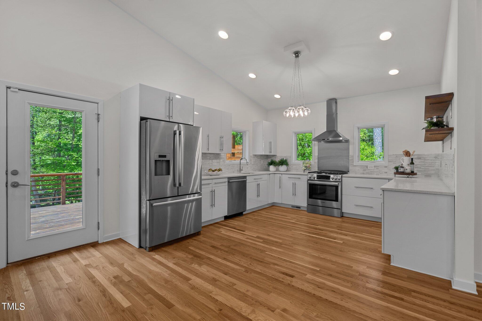 3546 Dixon Road Durham, NC 27707 - Photo 7 of 16 a kitchen with stainless steel appliances a refrigerator and a stove top oven