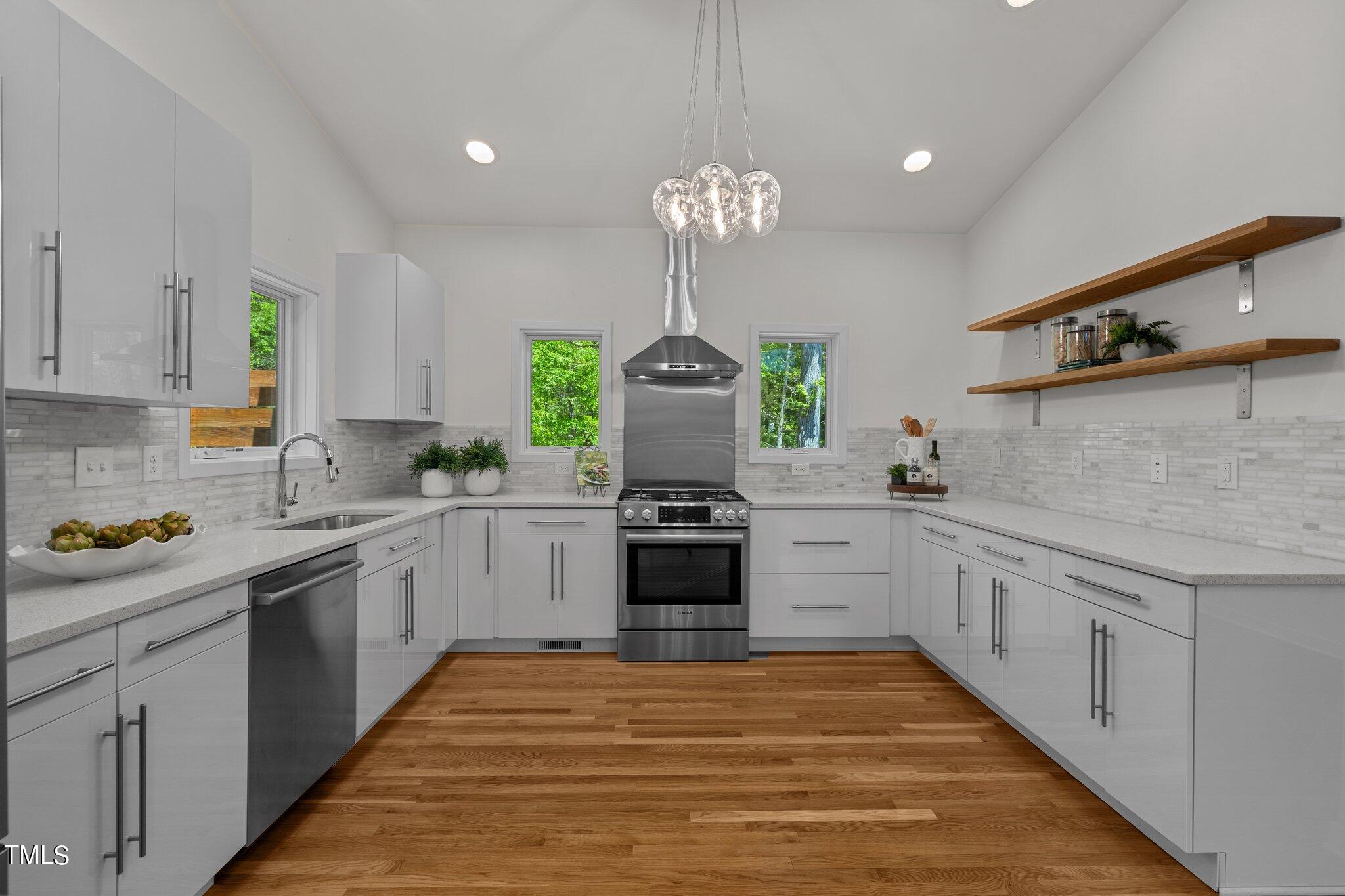 3546 Dixon Road Durham, NC 27707 - Photo 8 of 16 a kitchen with stainless steel appliances a stove sink and cabinets