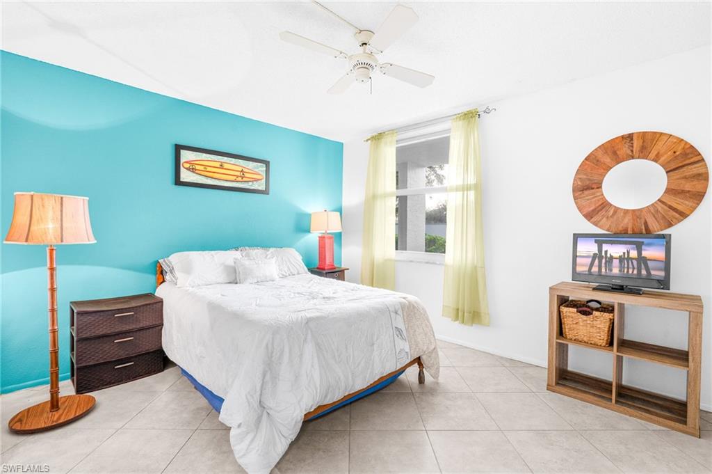 5959 Winkler Road, Unit 114 Fort Myers, FL 33919 - Photo 15 of 20 a bedroom with a bed and a table