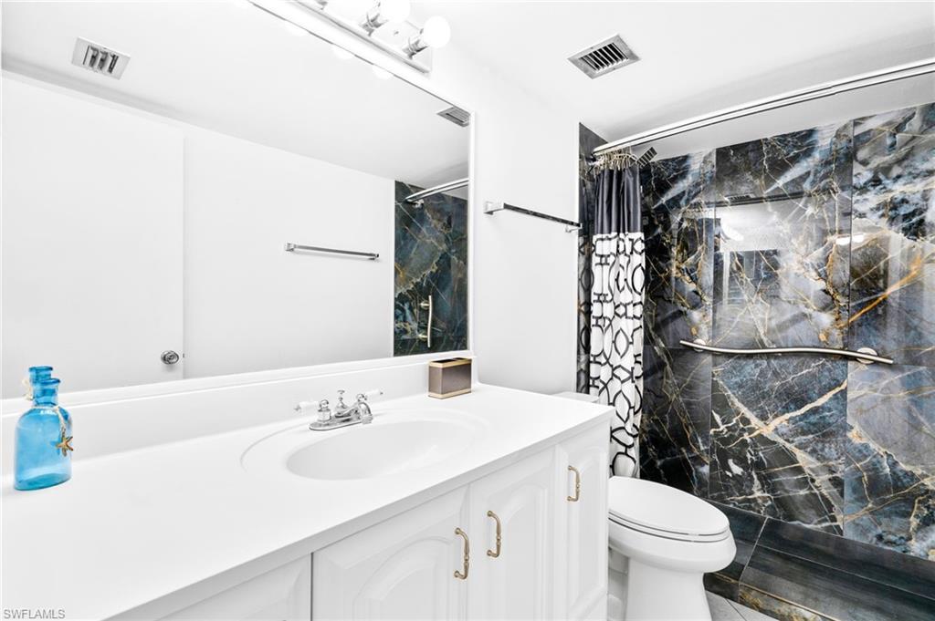 5959 Winkler Road, Unit 114 Fort Myers, FL 33919 - Photo 16 of 20 a bathroom with a sink toilet and shower