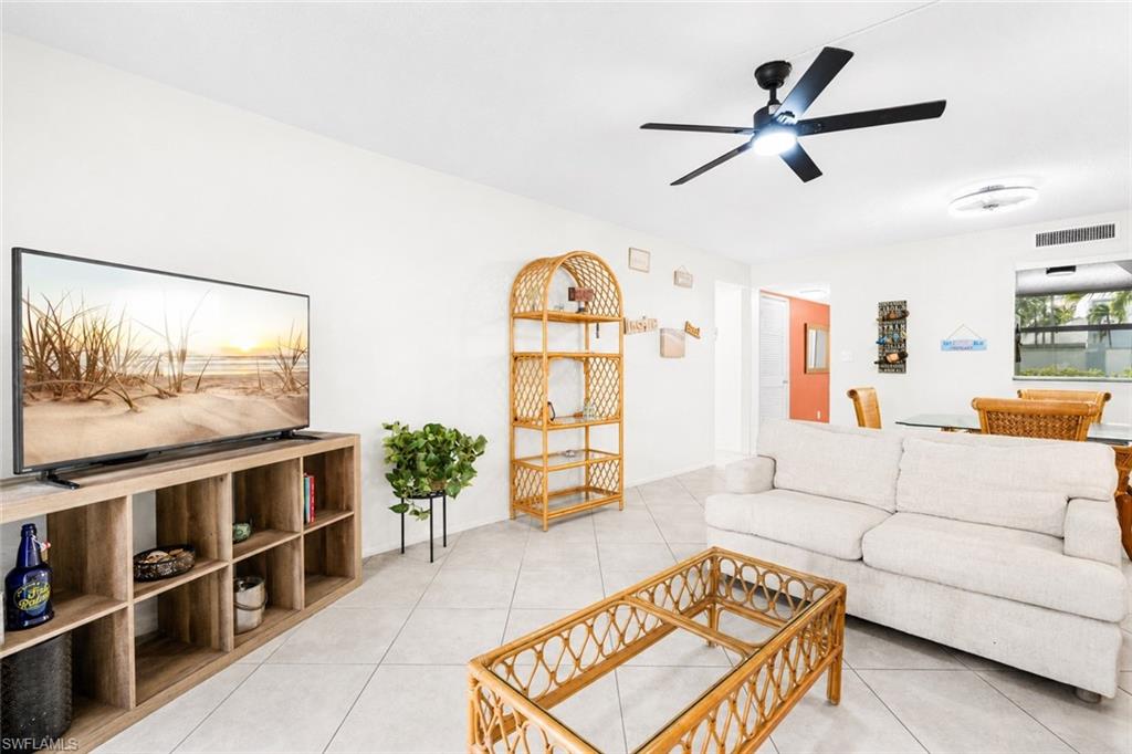 5959 Winkler Road, Unit 114 Fort Myers, FL 33919 - Photo 5 of 20 a living room with furniture and a flat screen tv
