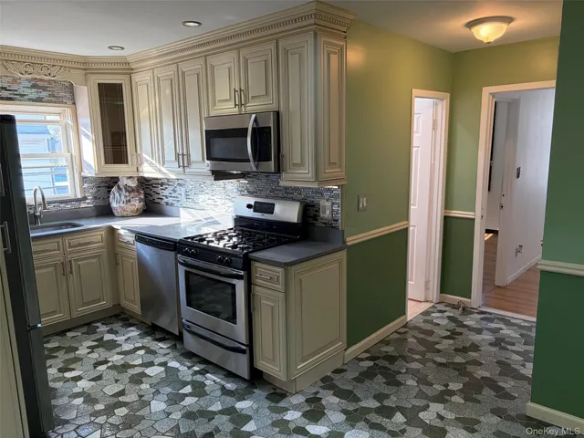 a bathroom with a granite countertop bathtub shower sink vanity and toilet
