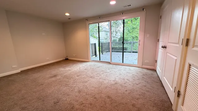 an empty room with windows and chandelier