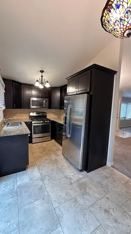 a bathroom with a granite countertop sink toilet a mirror and shower