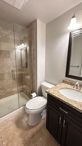 a view of livingroom with chandelier fan and kitchen view