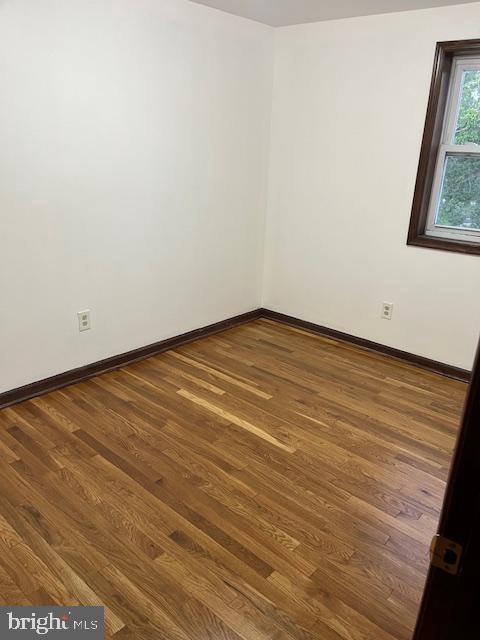 719 Taylor Drive Folcroft, PA 19032 - Photo 16 of 29 a view of an empty room with wooden floor and a window