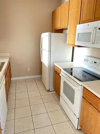 a kitchen with a stove top oven and cabinets
