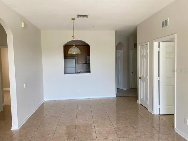 a view of a room with an entryway and chandelier