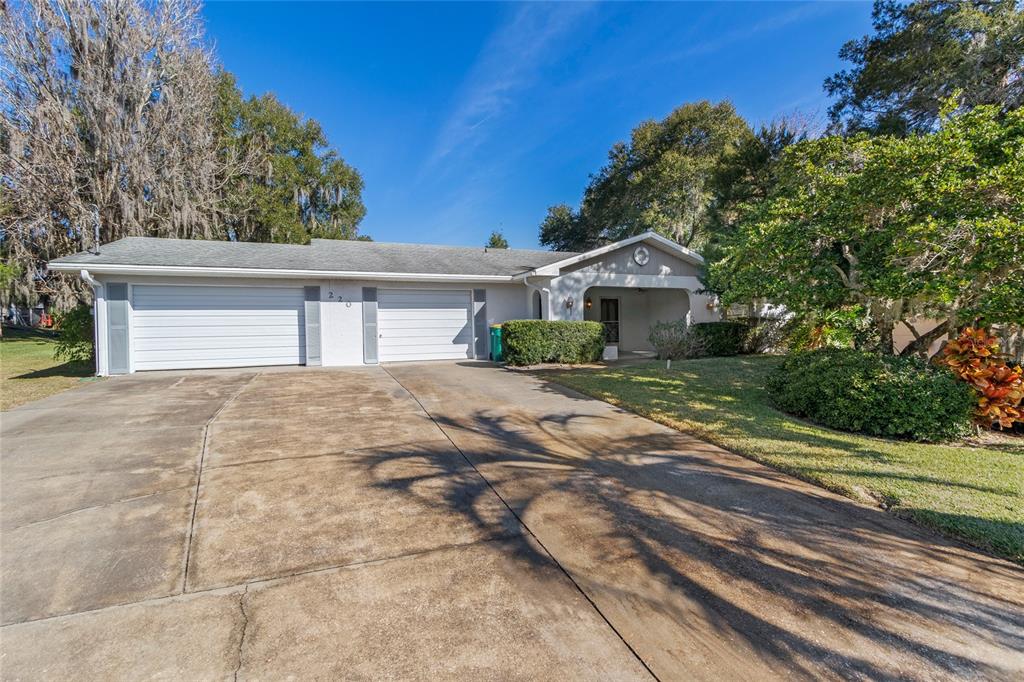 220 Temple Circle Eustis, FL 32726 - Photo 1 of 1 a front view of a house with a garden