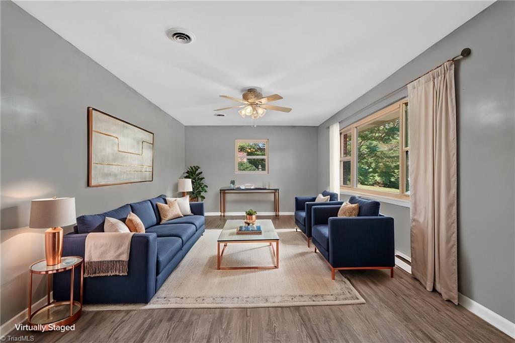113 Green Valley Road Greensboro, NC 27403 - Photo 3 of 46 Step inside to bright, welcoming spaces designed for everyday living and effortless entertaining. Large windows fill the home with natural light while preserving its classic mid-century charm. (Virtually Staged)