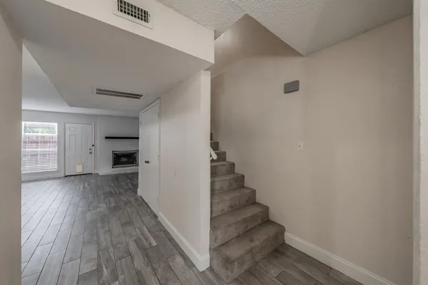a view of entryway and hall with wooden floor