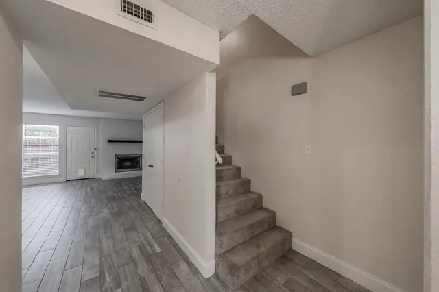a view of entryway and hall with wooden floor
