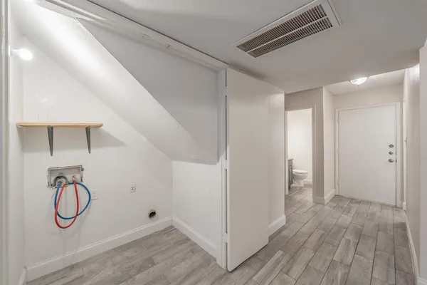 a view of a room with wooden floor and windows