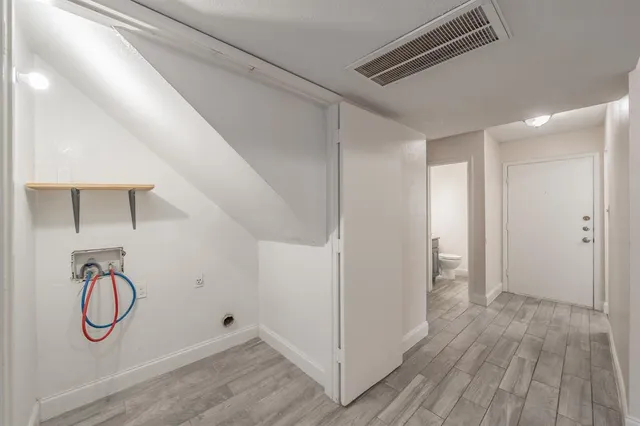 a view of a room with wooden floor and windows