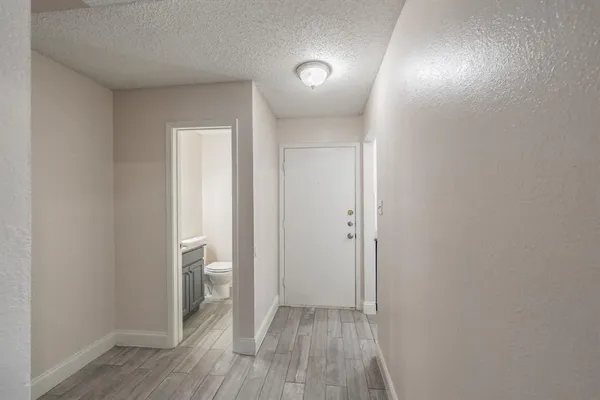 a view of hallway with wooden floor