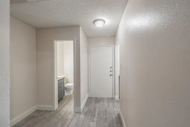 a view of hallway with wooden floor