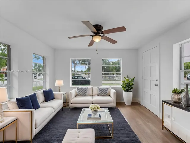 a kitchen with stainless steel appliances granite countertop a refrigerator a stove a microwave and cabinets