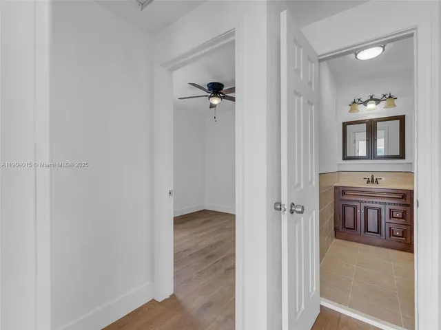 a bedroom with a bed and a potted plant