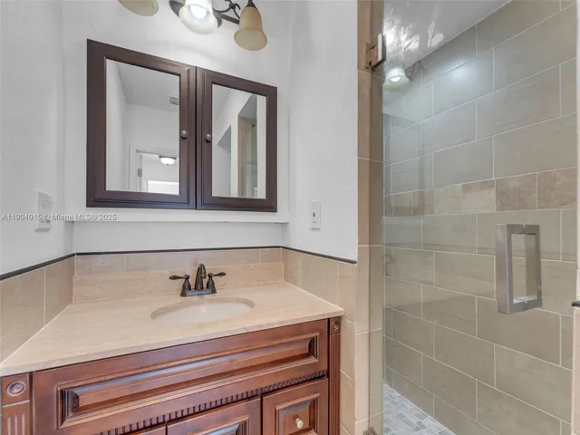 a view of a hallway with wooden floor and closet