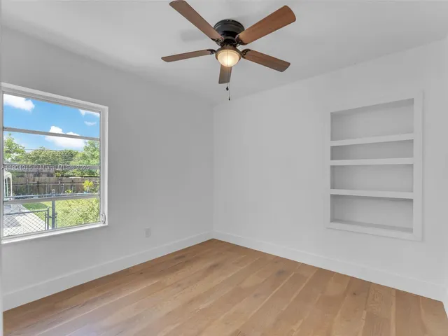 a kitchen with stainless steel appliances a stove a refrigerator and white cabinets