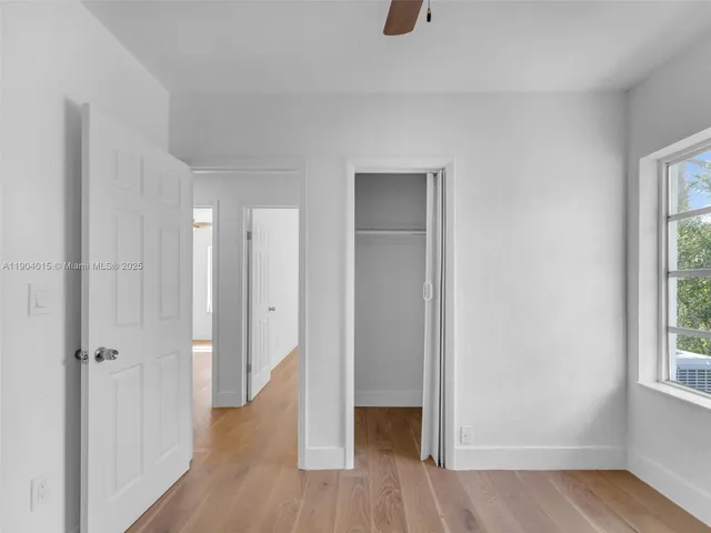 a view of a dining room with furniture and a chandelier