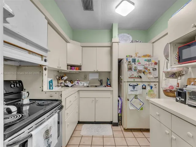 a bathroom with a sink a toilet and shower curtain