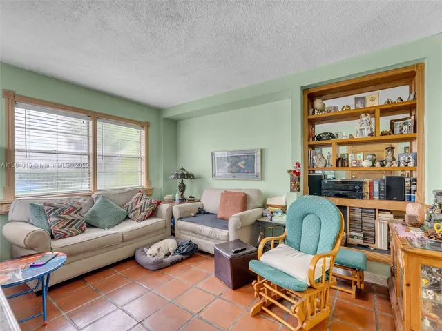 a bedroom with a bed and a view of kitchen