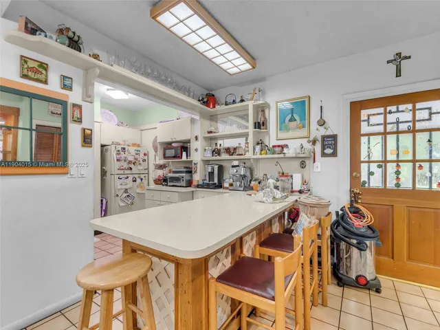 a view of a bedroom with baby bed and workspace