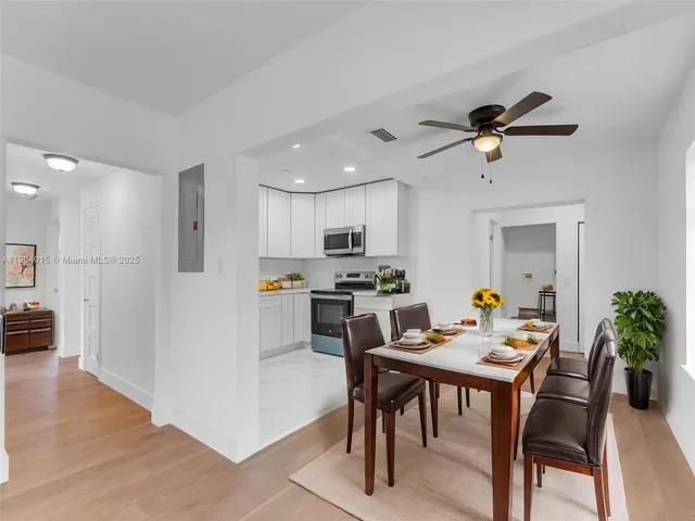 a kitchen with a sink a refrigerator a stove and cabinets