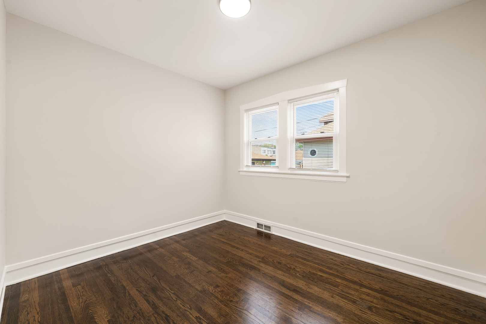 4230 North Monitor Avenue Chicago, IL 60634 - Photo 11 of 40 a view of a room with wooden floor and white walls
