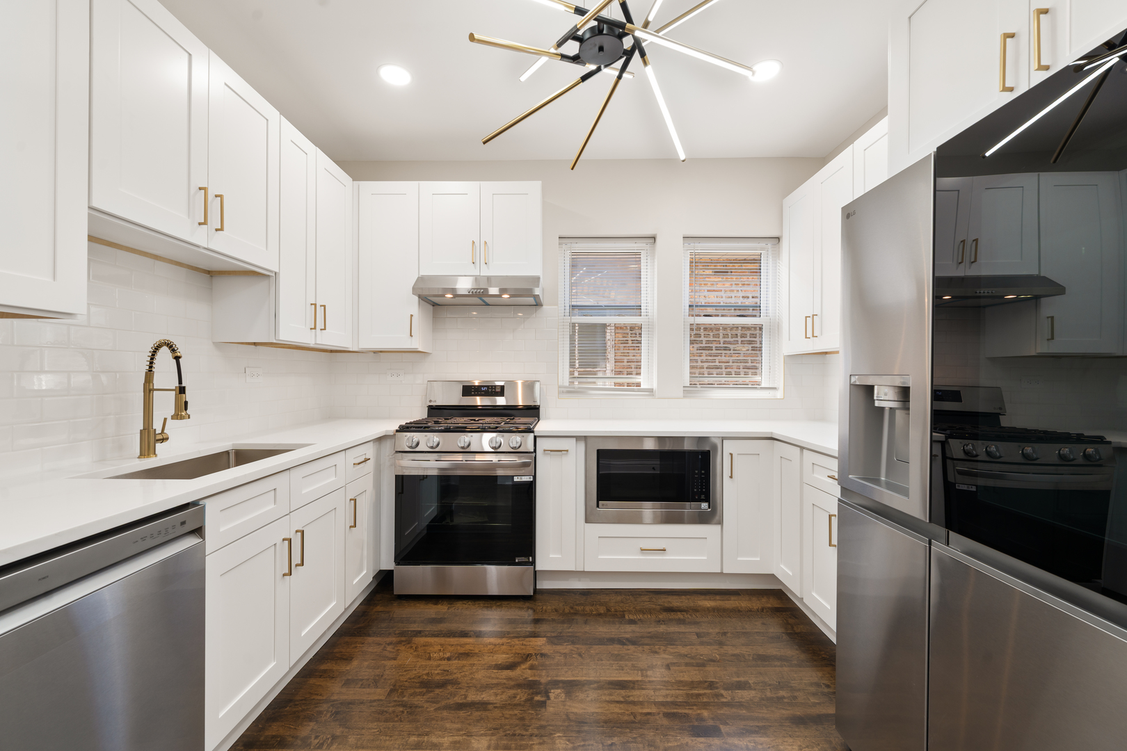 4230 North Monitor Avenue Chicago, IL 60634 - Photo 14 of 40 a kitchen with stainless steel appliances a stove sink microwave and cabinets