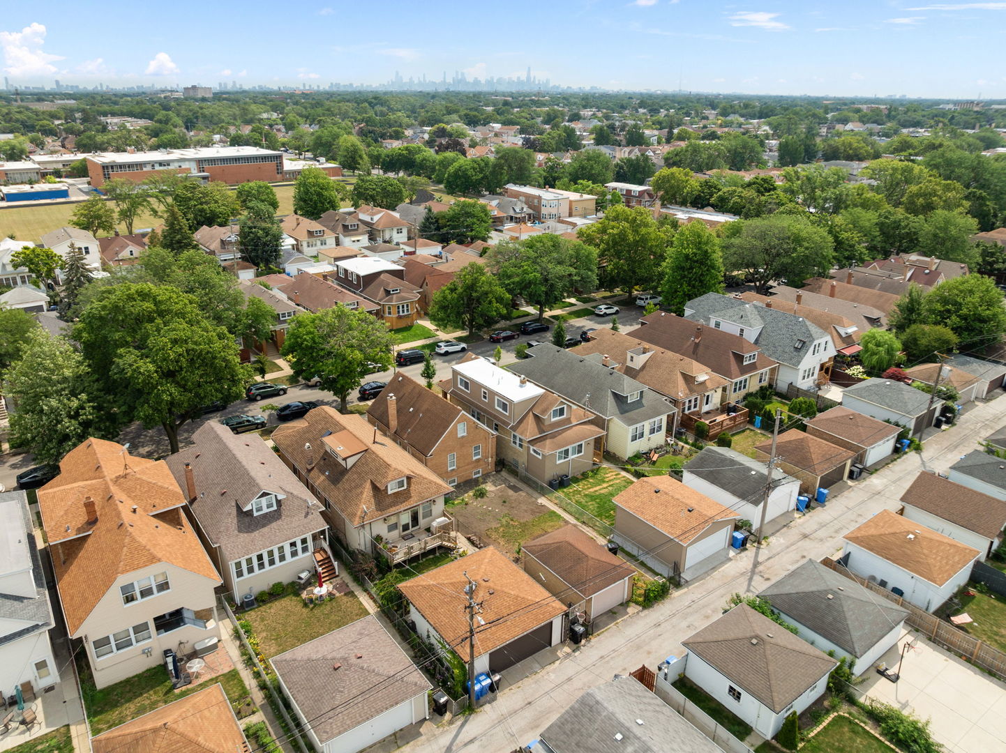 4230 North Monitor Avenue Chicago, IL 60634 - Photo 36 of 40 an aerial view of a city with lots of residential buildings and mountain view in back