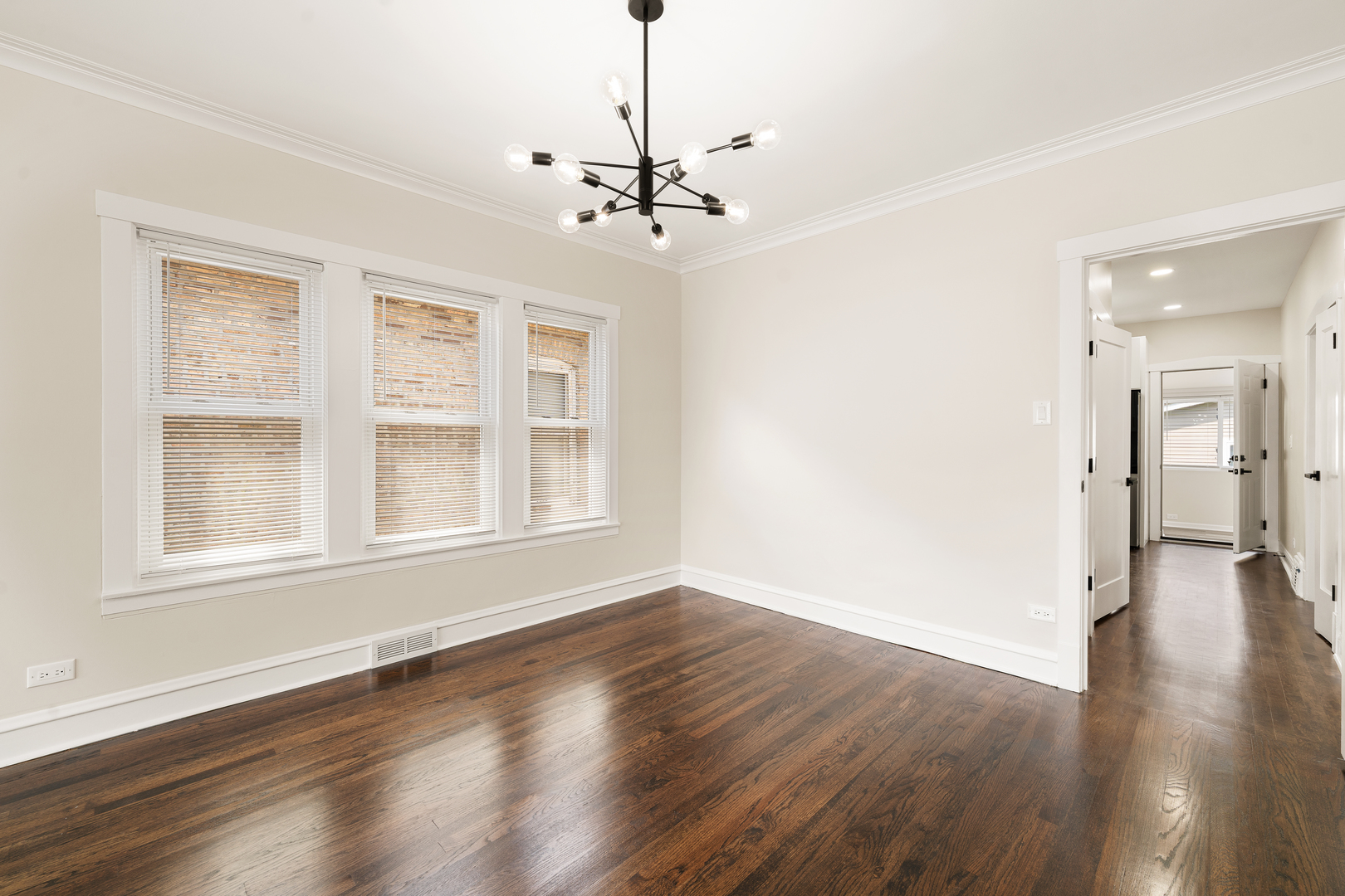 4230 North Monitor Avenue Chicago, IL 60634 - Photo 5 of 40 a view of an empty room with wooden floor and a window