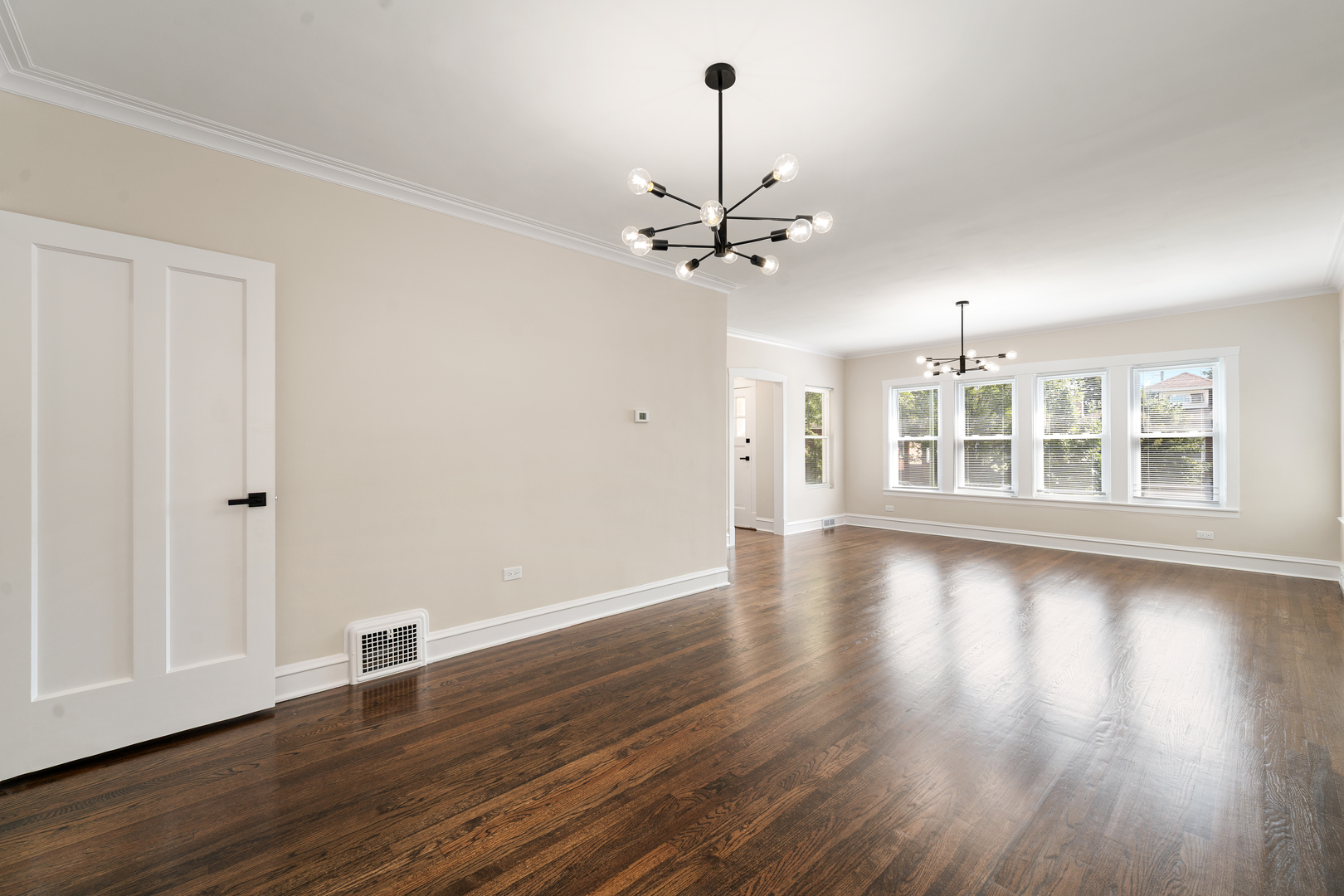 4230 North Monitor Avenue Chicago, IL 60634 - Photo 6 of 40 a view of a livingroom with wooden floor and a ceiling fan