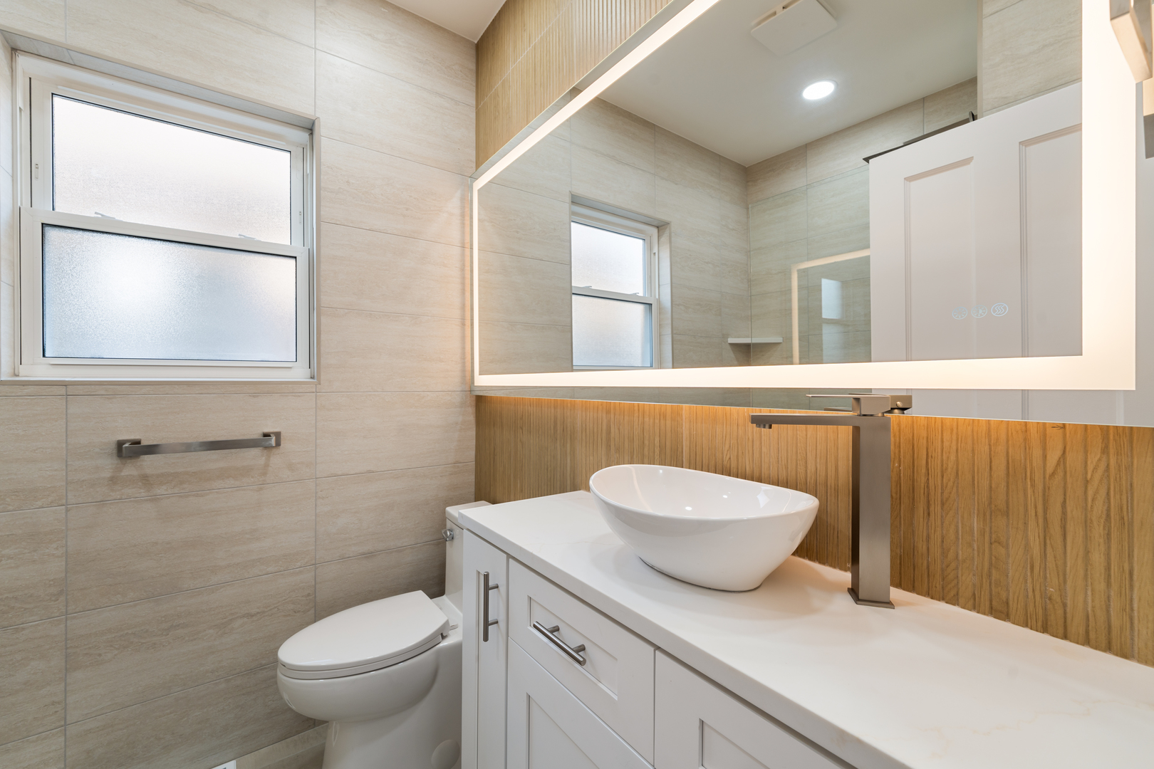 4230 North Monitor Avenue Chicago, IL 60634 - Photo 7 of 40 a bathroom with a toilet a sink and mirror